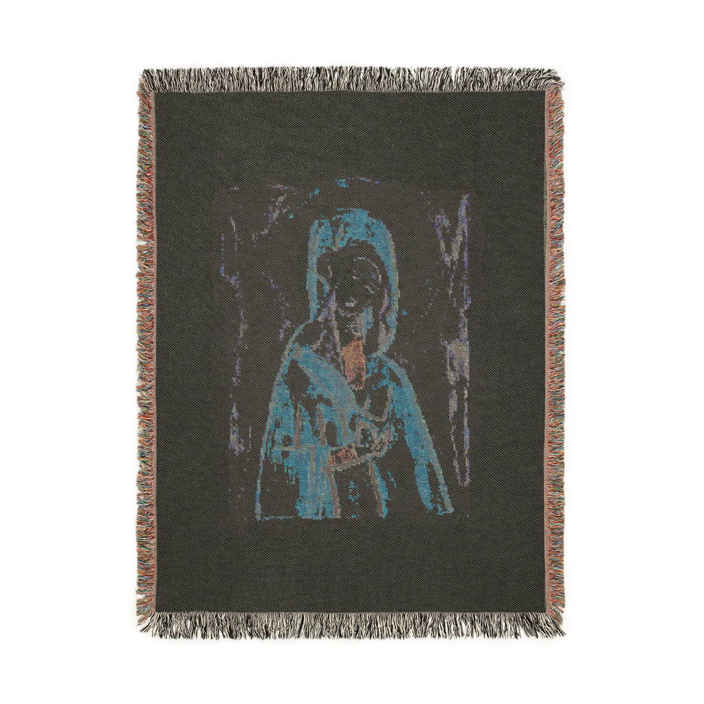 Woven blanket with a graphic design of a dog and landscape on a black background
